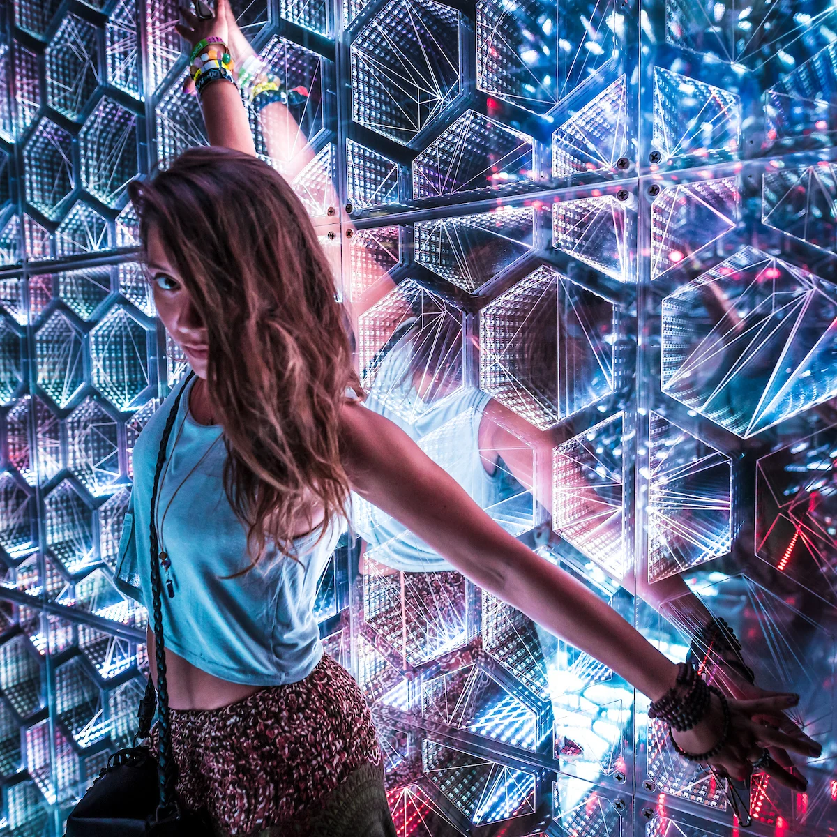 A visitor surrounded by mirrored light