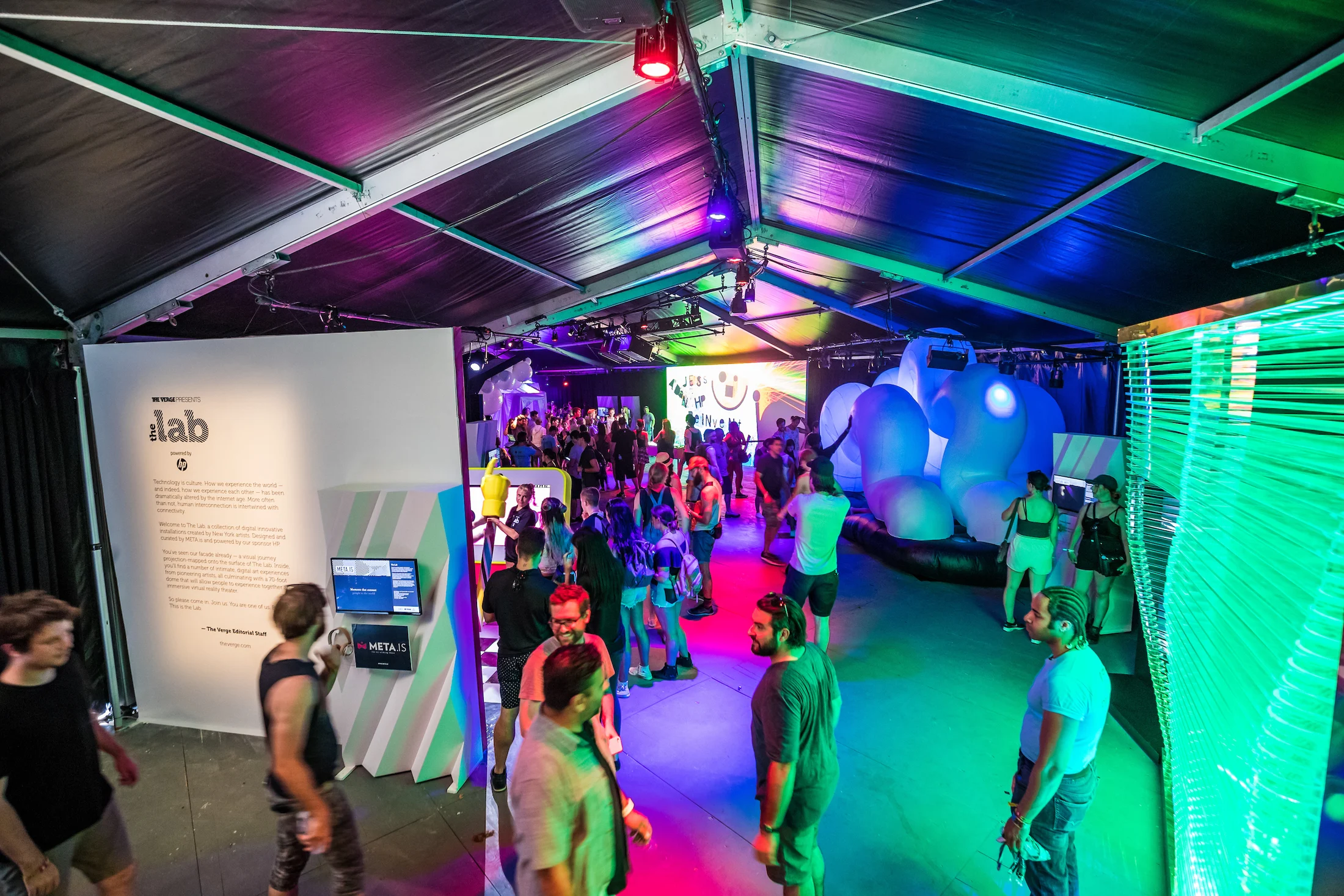 Visitors moving through the colorful LAB exhibition