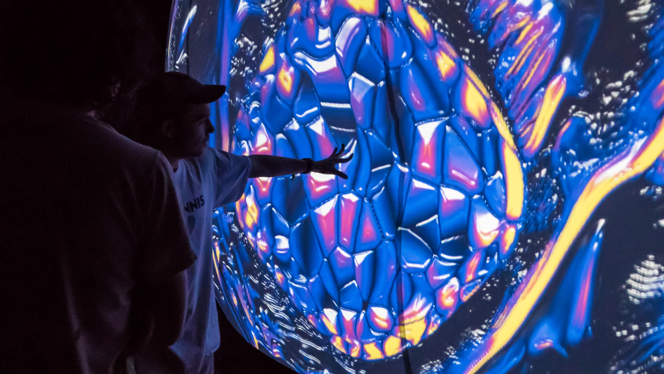 Visitors immersed in blue geometric imagery