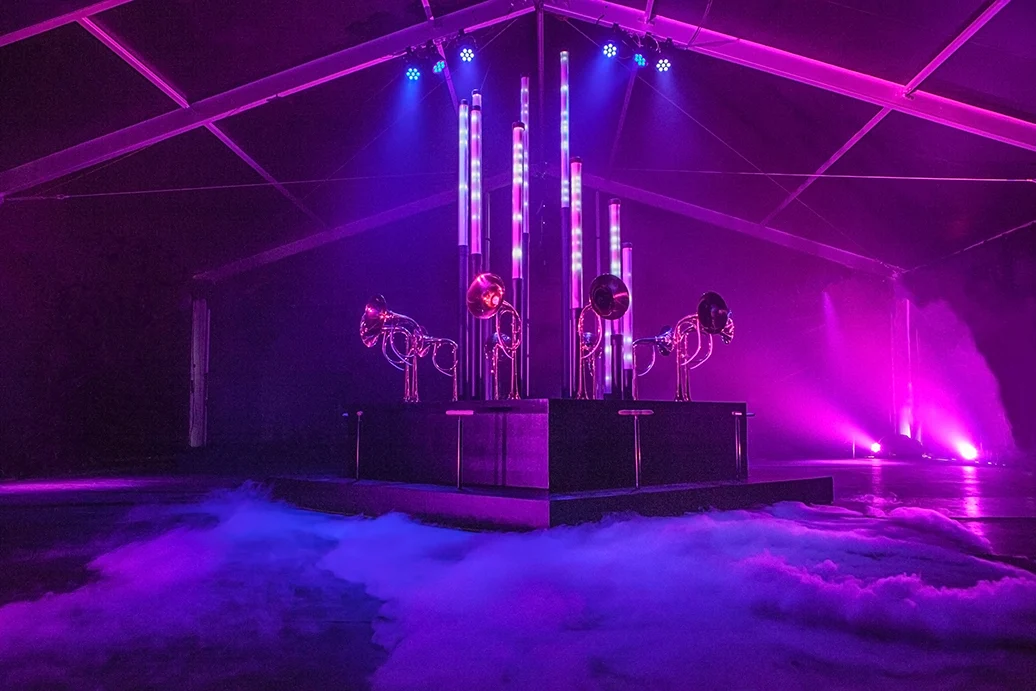 Dream Machine glowing purple on its platform