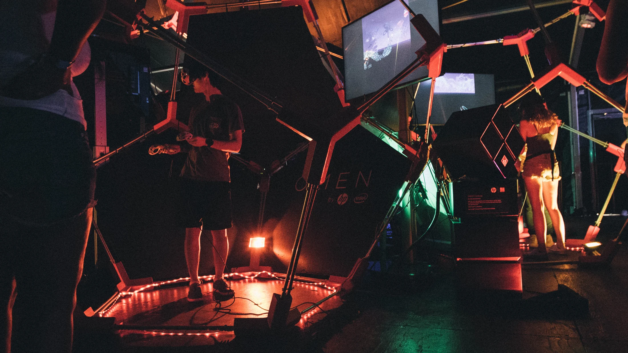 Visitors exploring red geometric projections