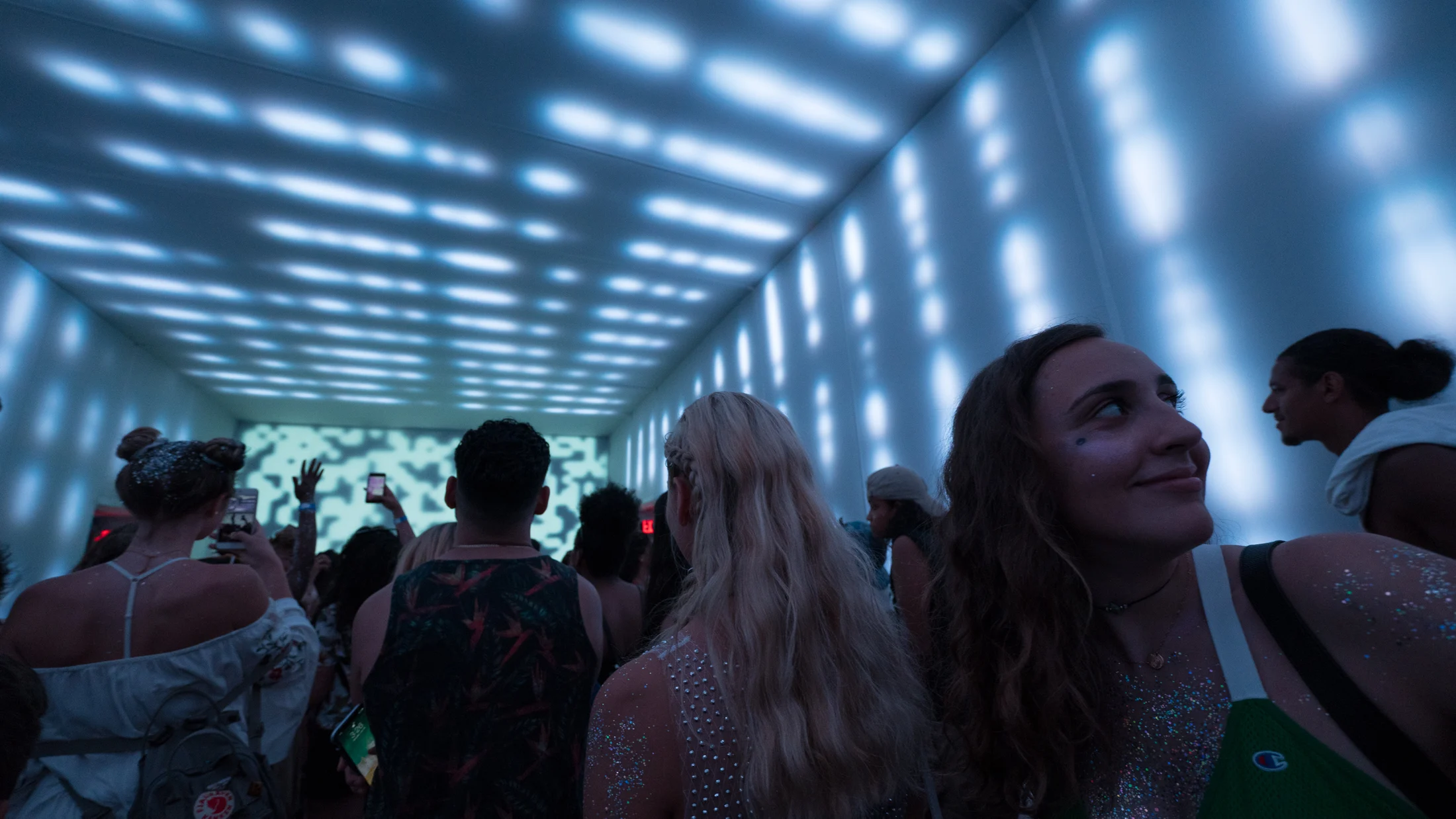 Visitors relaxing beneath softly illuminated spheres