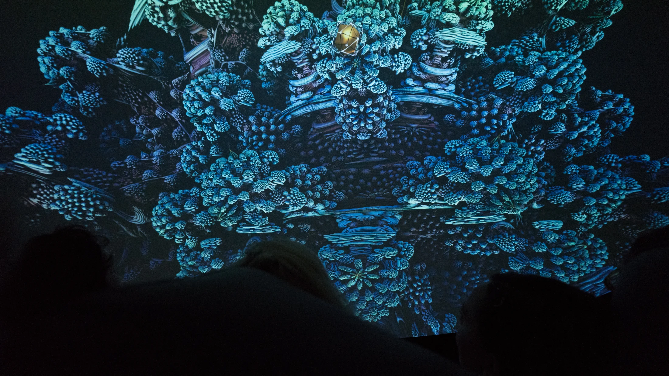 Visitors beneath intricate blue dome imagery